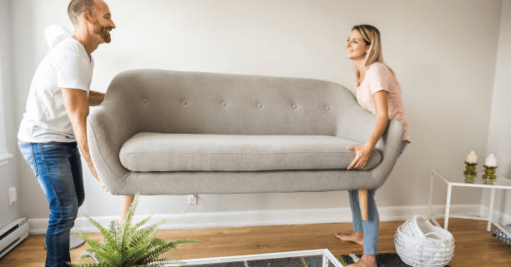 Couple moving sofa